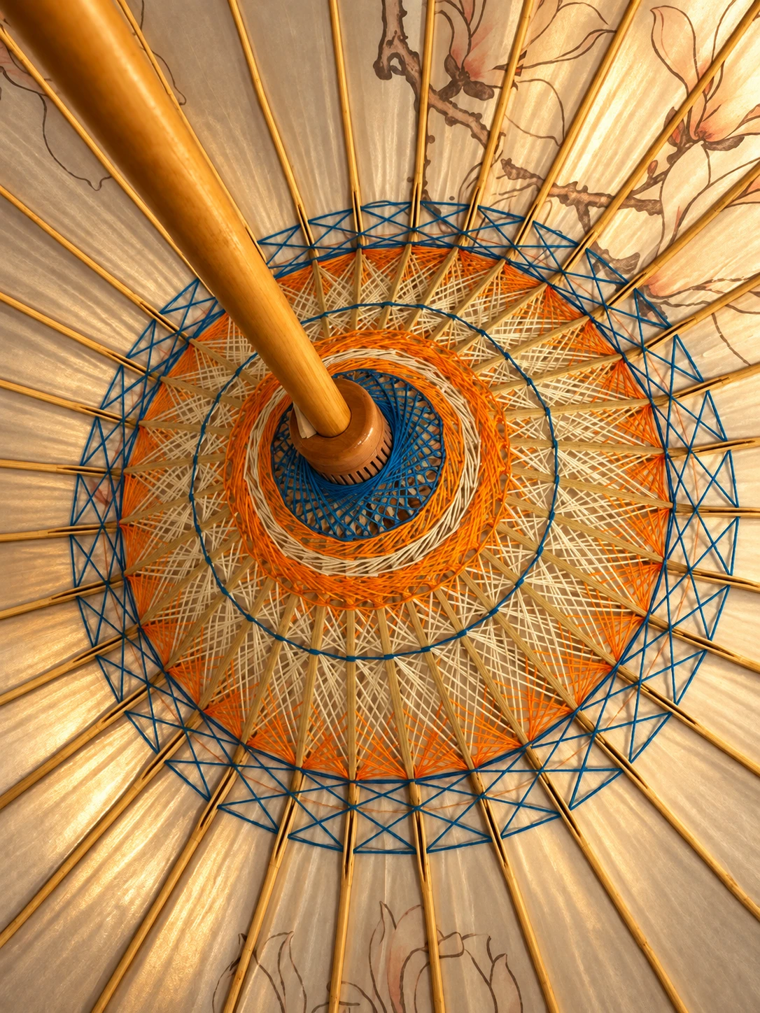 Warm-lit blue, ivory and orange threadwork based on the supplied SHENGHE umbrella reference.